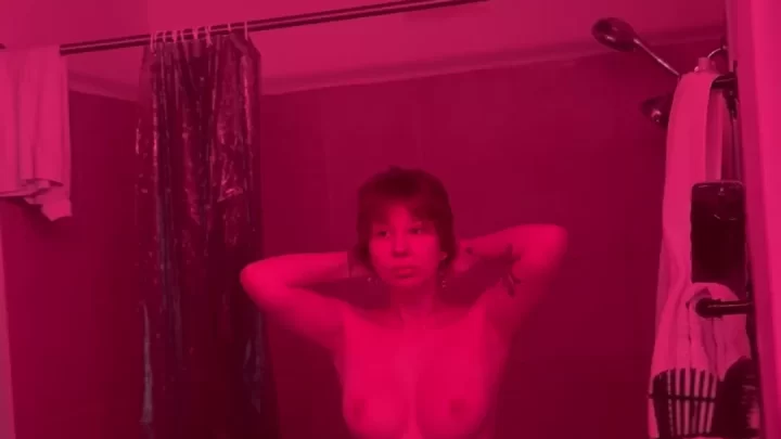 Brunette with tattoos poses nude in bathroom