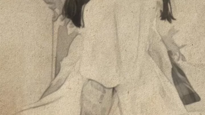 Mature Asian Woman Sitting on Chair, Looking Over Shoulder