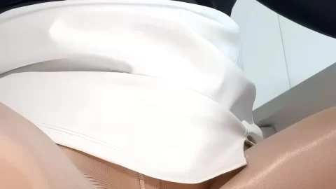 Blonde girl lifting skirt, spreading legs on office chair