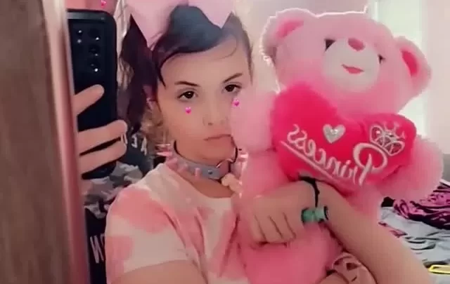 Petite brunette with pink bow bends over