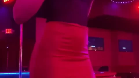 Brunette with big tits dancing and posing in nightclub