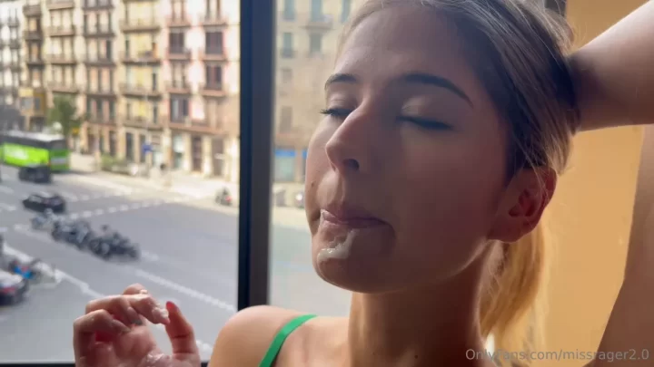Blonde girl eats sweets by window
