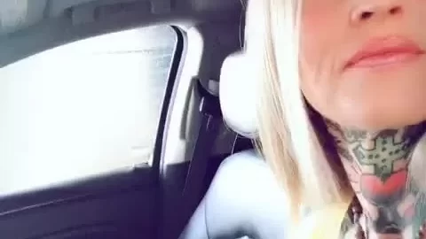 Blonde girl plays with herself in a car