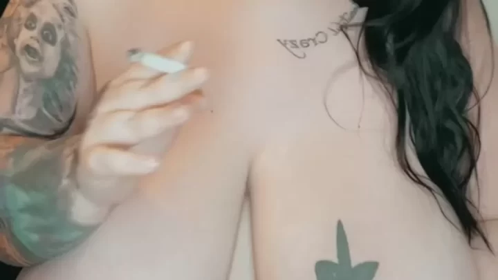 Tattooed brunette takes selfies, smokes