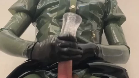Slim girl in latex catsuit plays with dildo