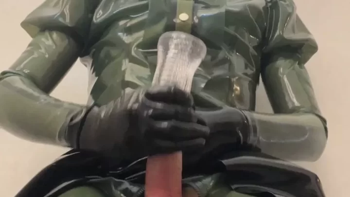 Slim girl in latex catsuit plays with dildo