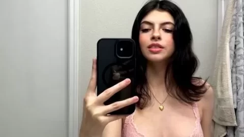 Brunette teen takes selfie in pink lingerie