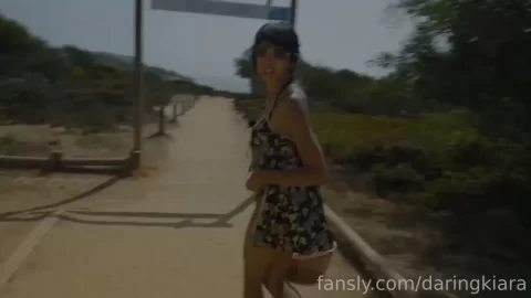Slim white girl with tattoo walks and poses outdoor
