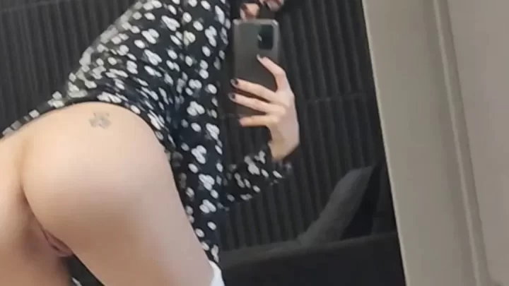 Asian girl with tattoo on buttock bends over in bathroom