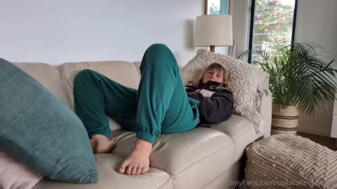 blonde girl relaxes on couch