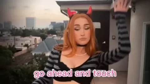 Redhead in devil horns teases on balcony