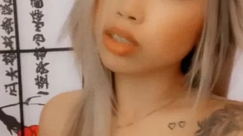 Blonde Asian Girl with Tattoos Poses and Covers Herself