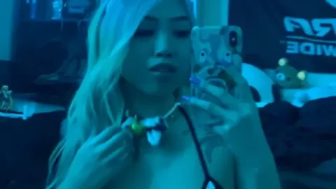 Blonde Asian girl in cow-print lingerie takes selfie