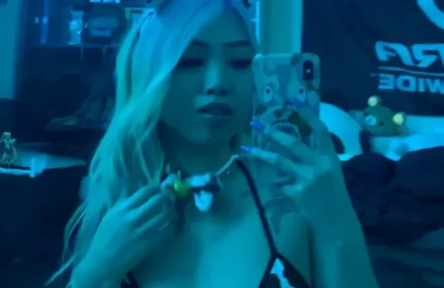 Blonde Asian girl in cow-print lingerie takes selfie