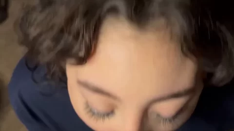 Brunette girl gives white guy blowjob on bed
