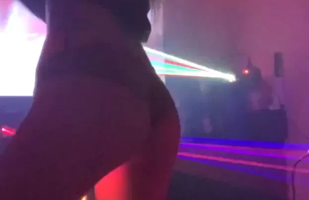 Brunette with tattoo dances in laser light party