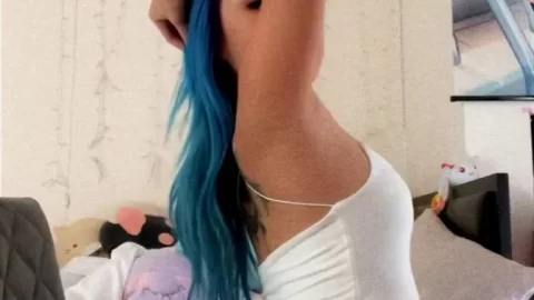 Blue-haired girl plays with herself on bed