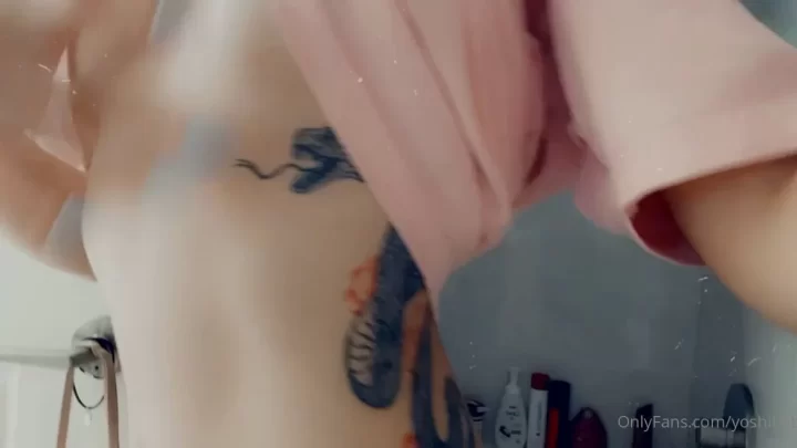 Slim white girl with torso tattoo gets naked in bathroom