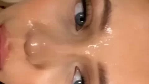 Blonde girl licks lips in bathroom