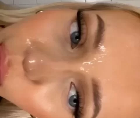 Blonde girl licks lips in bathroom