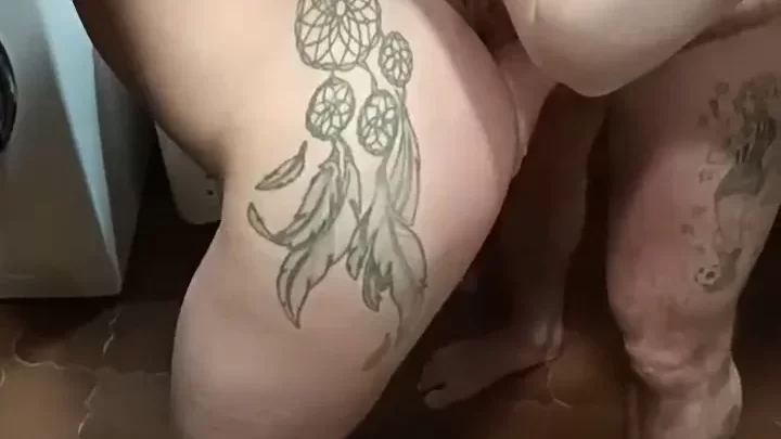 Blonde woman bending over in bathroom