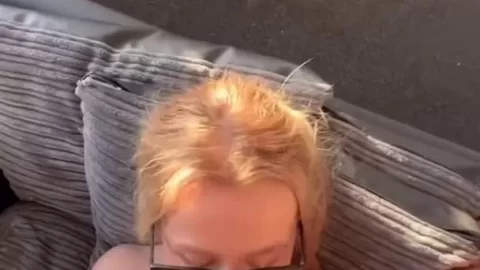 Blonde girl gives blowjob on couch